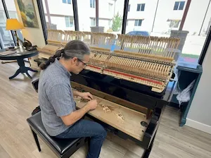Tuning an old upright piano in Bosque Farms.